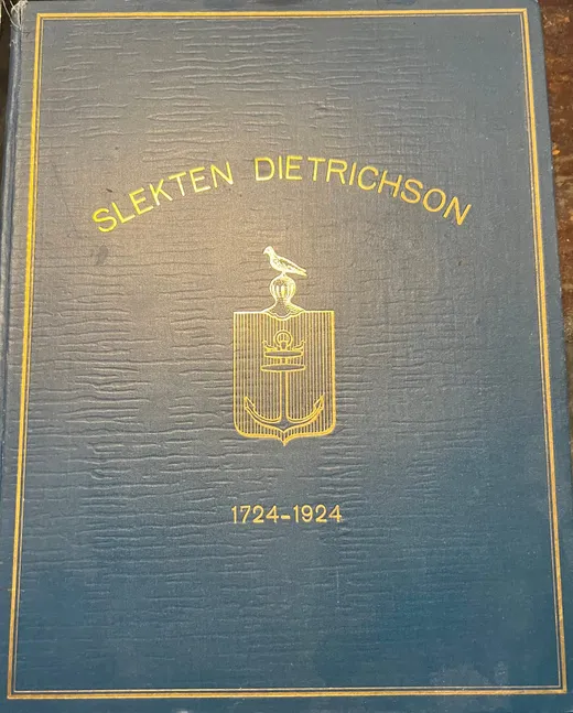 Forside av boka «Slekten Dietrichson 1724–1924», blått lerret med gullramme, skjold med hjelm og due, og tittelen i gull